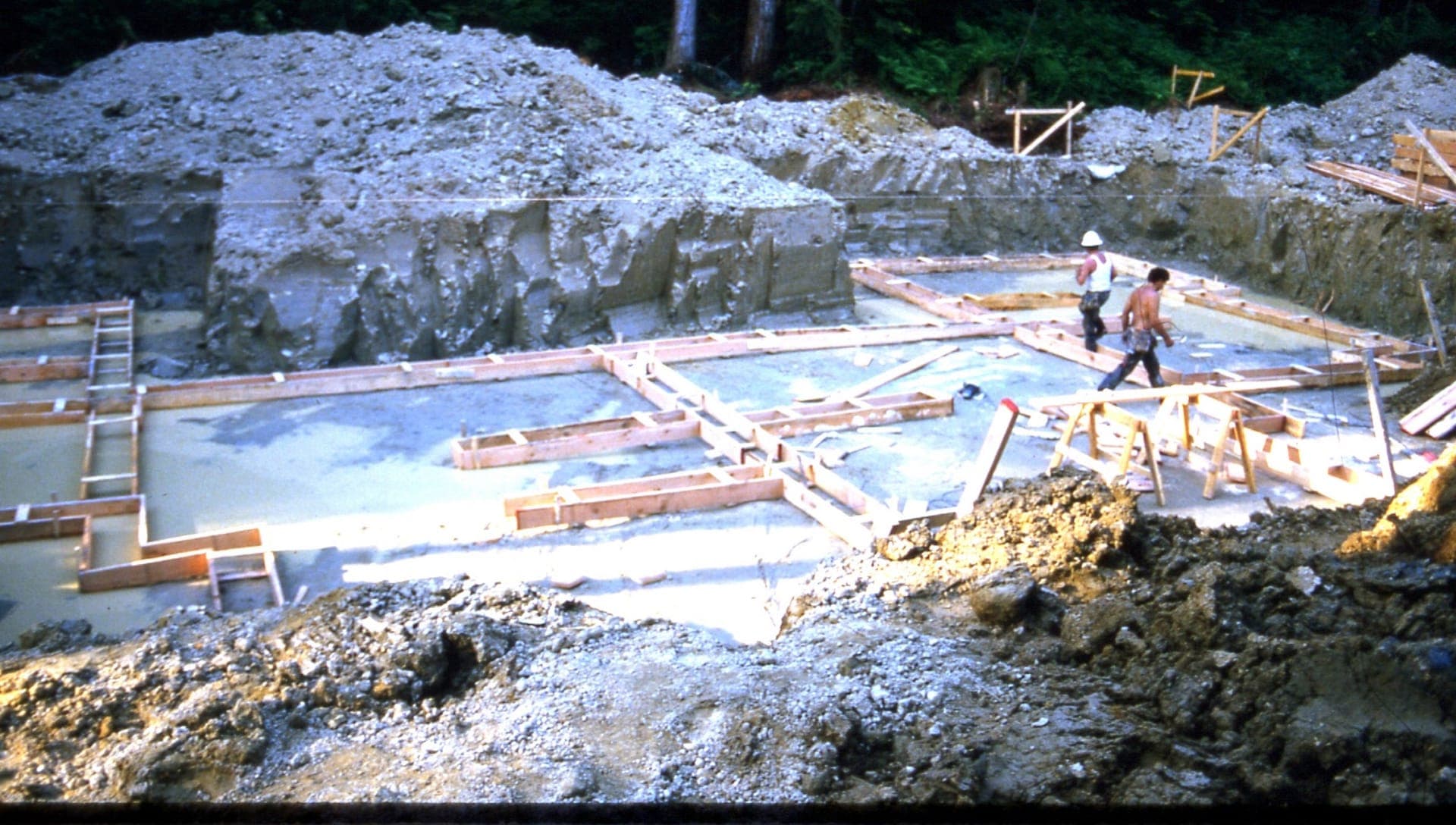 Workers on the freshly poured foundation slab